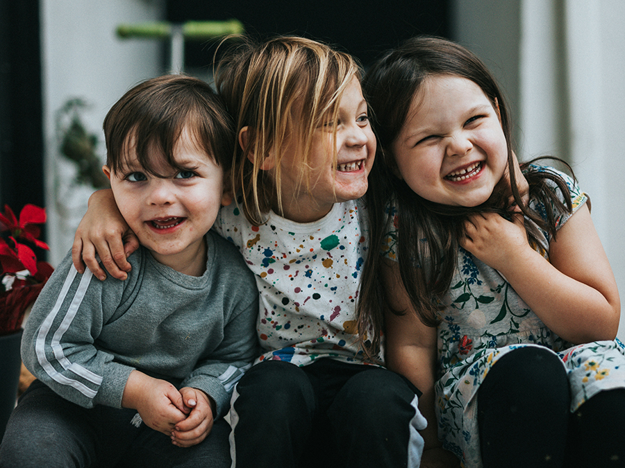 Three kids laughing.