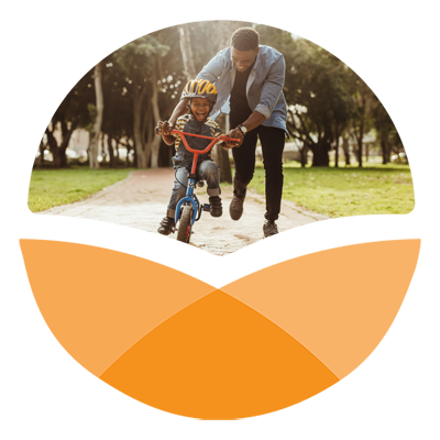 Orange stylized circle with photo in top portion of African American man teaching his son to ride a bike