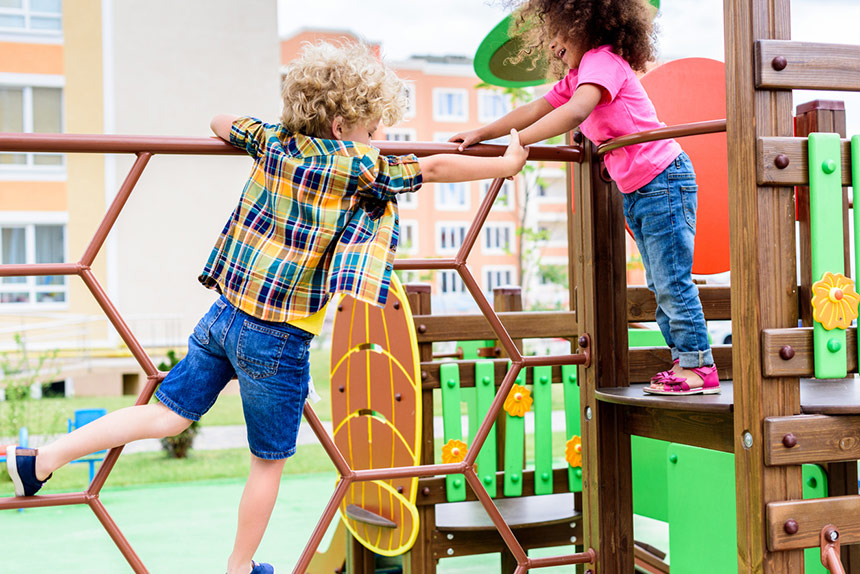 Children playing on jungle gym in park