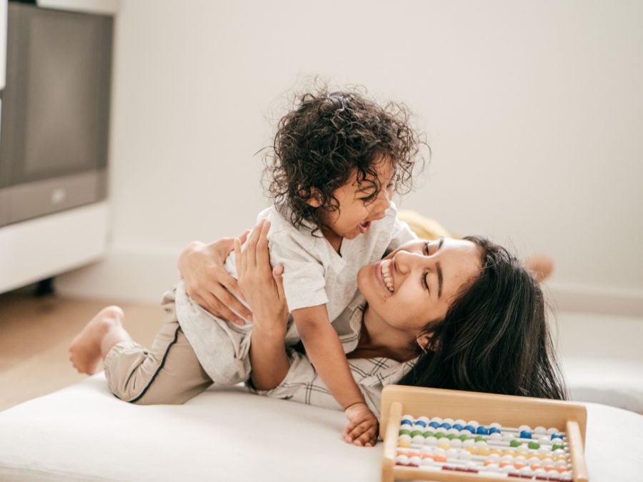 Mother and child playing and laughing.