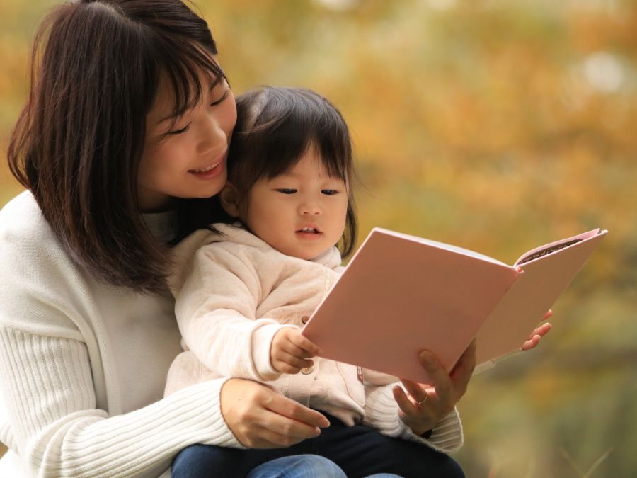 Mother reading to child.