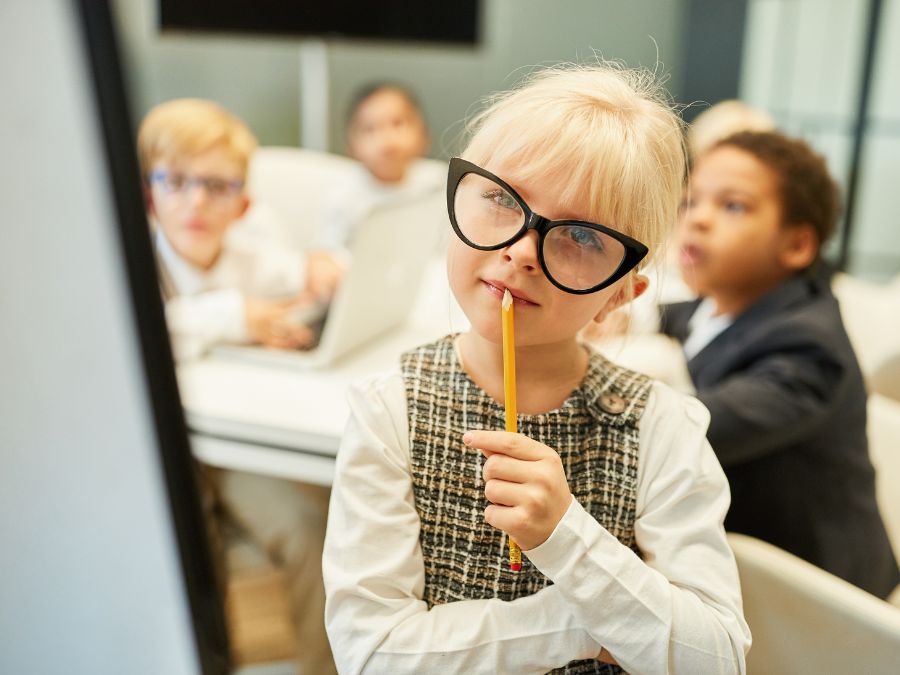 Child with pencil and big glasses.