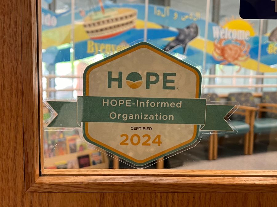 HOPE-informed Organization decal sticker on front door of clinic.