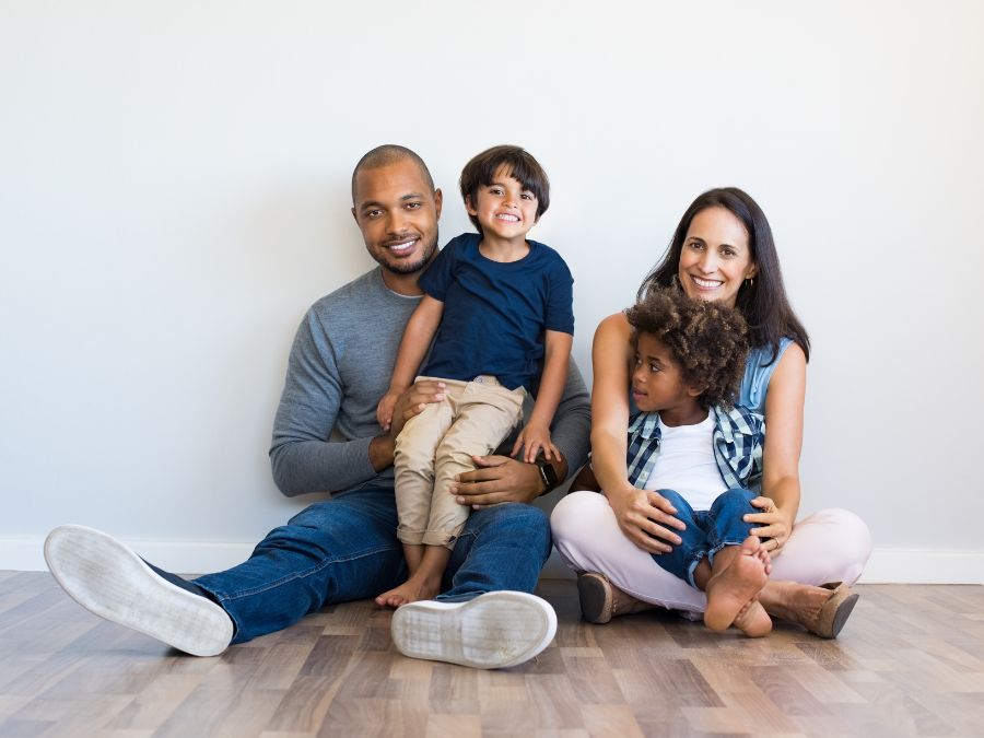 Family sitting together on the floor.