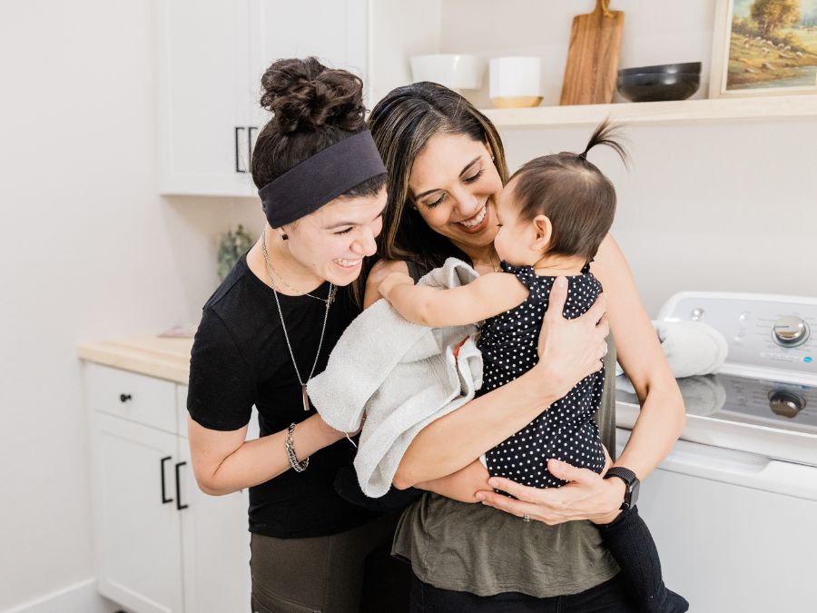 Two mothers with their baby.