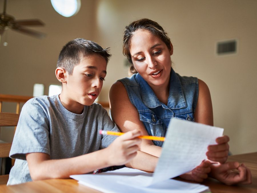 Student getting help from an adult with homework.