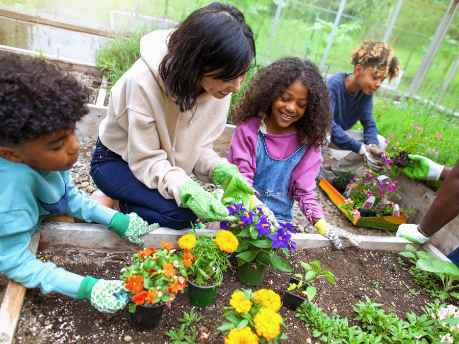 Adult and children planting flowers