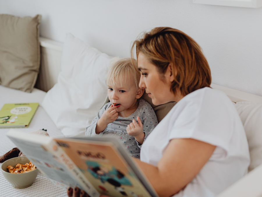 Mother reading to her young child.