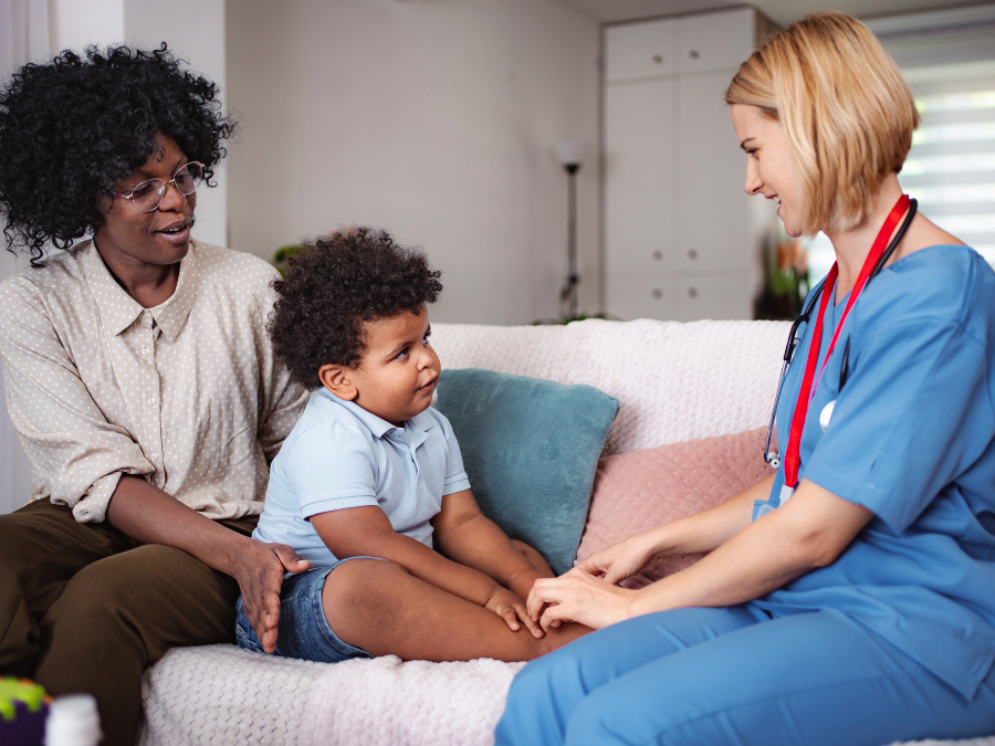 Mother and child with home visiting practitioner.