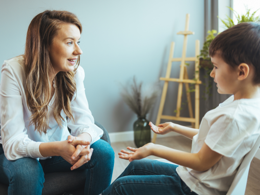 Adult and child sitting together having a conversation.