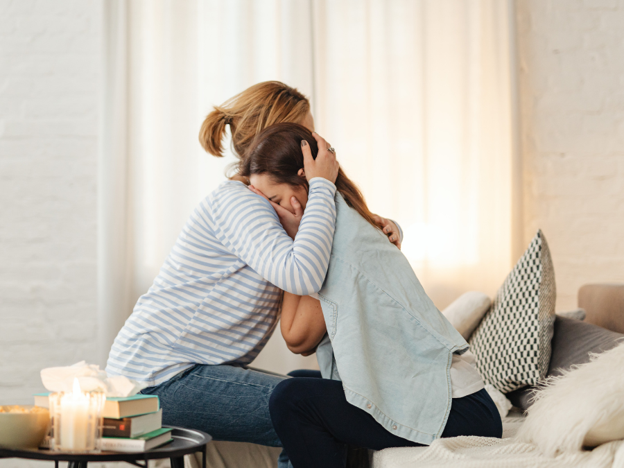Caregiver and child hugging