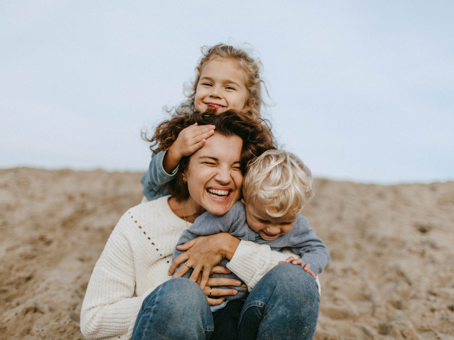 Parent and children laughing and hugging